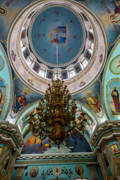 Interior view of the Cathedral of St. Peter and St. Paul showcasing colorful murals and a large chandelier in Gomel