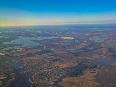 Vast aerial view of the Arctic landscape showing water bodies and landforms in Nenets Autonomous Okrug, Russia