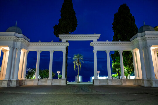 Elegant buildings light up the ocean promenade in Sukhumi, Abkhazia, creating a nighttime view