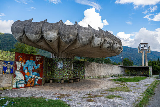Old bus stop features mosaics and unique design located in Gagra, Abkhazia with a scenic backdrop and cloudy sky