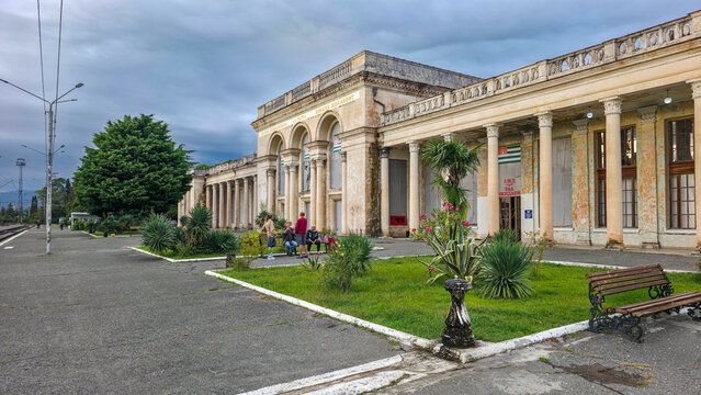 Visitors gather outside Gagra railway station in Abkhazia on a cloudy day in Russia