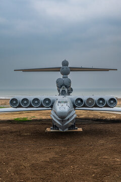 Modern aircraft sits on the ground with engines visible in Dagestan, Russia during a cloudy day