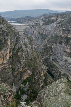 View of rocky landscape and dam in Dagestan, Russia, showcasing the natural terrain and waterway below