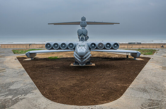 Military helicopter displayed in Dagestan with cloudy sky and shoreline in background