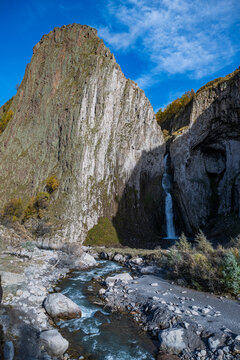 Sultan waterfall flows from rocky cliffs in Kabardino-Balkaria near Mount Elbrus