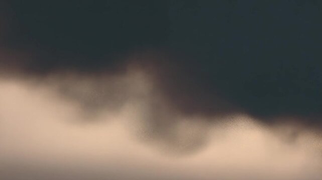 Dramatic Sky: An evocative scene unfolds with the interplay of ominous, dark clouds contrasting against a soft, ethereal glow, creating an atmosphere of anticipation.