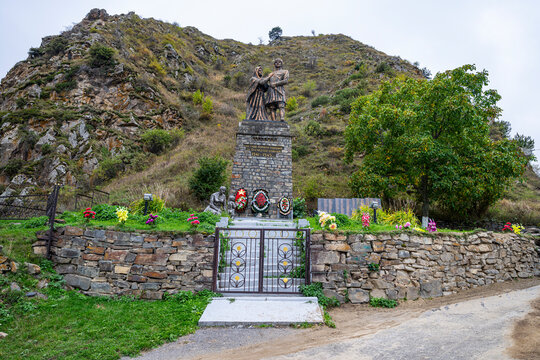 Hero statue stands on a hill in North Ossetia surrounded by flowers and greenery