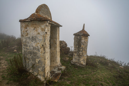 Fog covers ancient structures of Lezgor Necropolis in North Ossetia, Russia on a quiet day