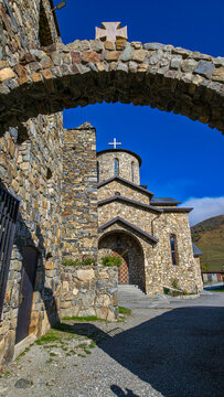 Stone architecture of Alanskiy Svyato-Uspenskiy Mu zhskoy Monastry in North Ossetia with clear sky in background