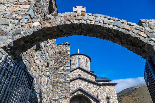 Exploring the stone architecture of Alanskiy Svyato-Uspenskiy Muzhskoy Monastry in the Caucasus mountains during daylight in North Ossetia, Russia