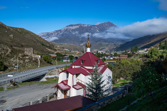 Visit to Alanskiy Svyato-Uspenskiy Muzhskoy Monastry in North Ossetia, Russia with mountains in the background