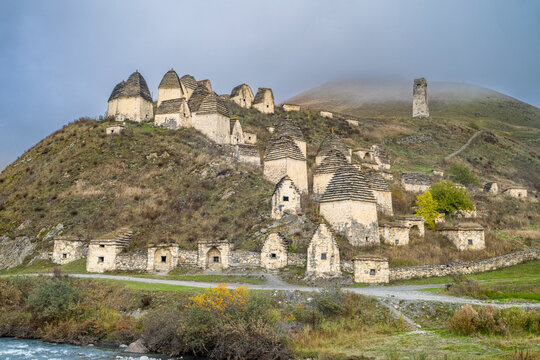 Historic burial site showcases ancient architecture in Dargavs, North Ossetia, Russia with mountain backdrop