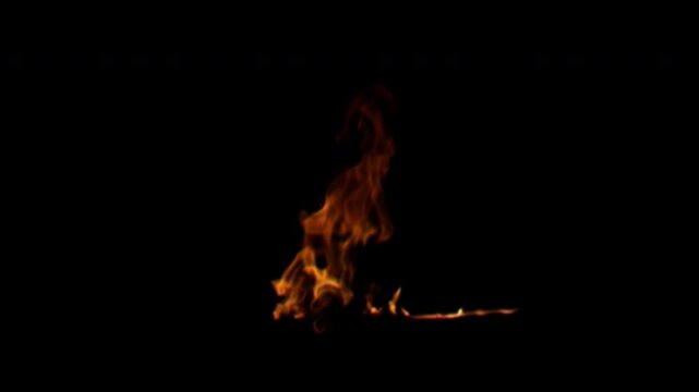 Realistic small fire burning with flickering orange flames isolated on a black background for compositing.