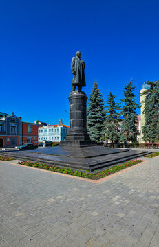 Lenin statue in Vladikavkaz surrounded by buildings and trees on a clear day in North Ossetia, Russia