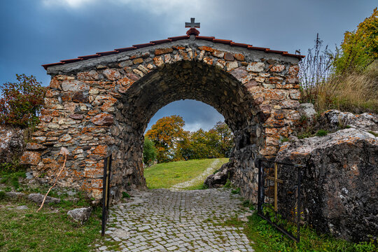 Entrance gate leading to St. George Church in South Ossetia showcasing stone structure and pathway