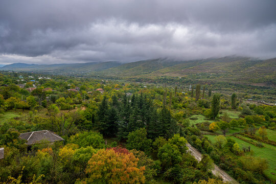 View from Ikoti Monastery overlooking green hills and villages in South Ossetia during an overcast day