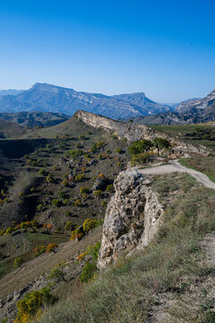 Terraced fields show farming practices in Dagestan, Russia with mountains in the background during clear weather