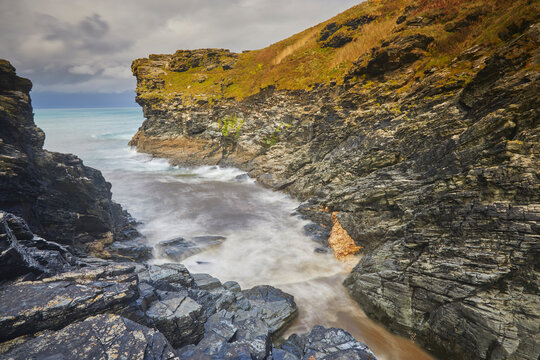 Rocky cove where Rocky Valley meets the Atlantic Ocean near Boscastle in Cornwall showing rugged coasts and gentle waves