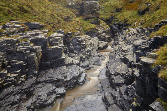 Rocky gorge in a valley near Boscastle reveals winding stream and rugged terrain in Cornwall