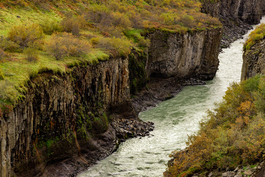 Hvit River flows through basalts with autumn colors in Iceland's canyon landscape