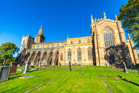 Visit to Dunfermline Abbey with detailed architecture and surrounding graveyard during a sunny day in Fife, Scotland