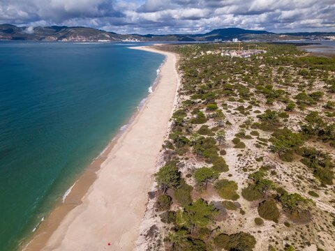 View of Comporta and Troia beaches near Setubal Portugal with Arrabida mountains in the background captured from a drone