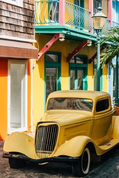 Bright streets of Philipsburg feature vintage car parked near colorful colonial houses and vibrant architecture