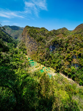 Elevated view of natural pools and hills in Semuc Champey, showcasing the beauty of Lanquin, Guatemala