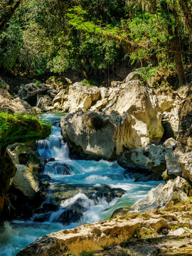 Cahabon River flows over rocks near Semuc Champey Natural Monument in Lanquin, Guatemala, showcasing natural beauty and diverse landscape features