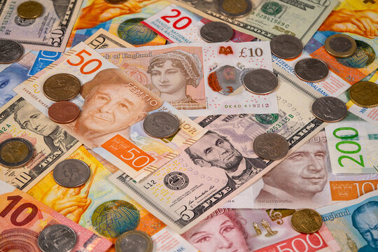 Various banknotes and coins from different countries on a table