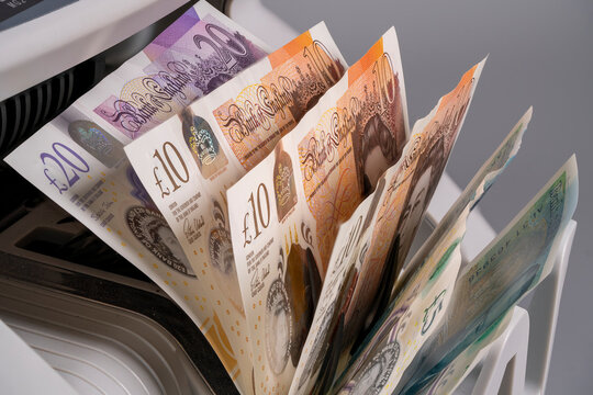 Display of British pound sterling notes in a currency exchange machine
