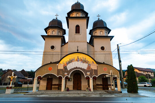 Orthodox church stands under heavenly light in Romania during early morning