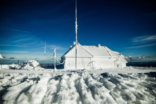 Icicles form on structures in a frozen landscape during winter in Romania, showcasing natural beauty and extreme weather