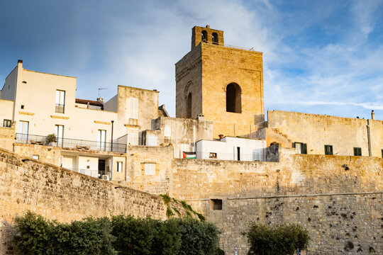 View of historic buildings and clock tower in Otranto during sunset in Puglia region Italy