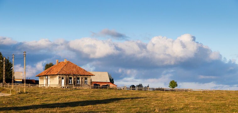 Scenic rural house set against the sky in a remote mountain village of Romania during the day