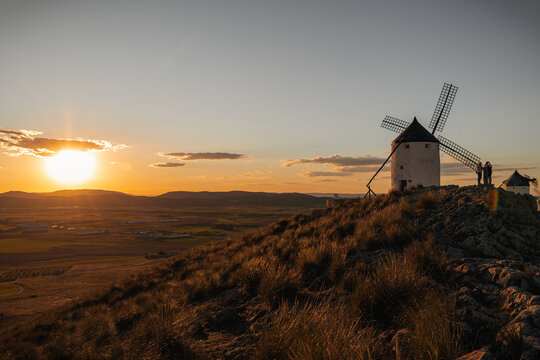 Consuegra windmills at sunset, iconic La Mancha landscape inspiring Don Quixote's adventures in Spain
