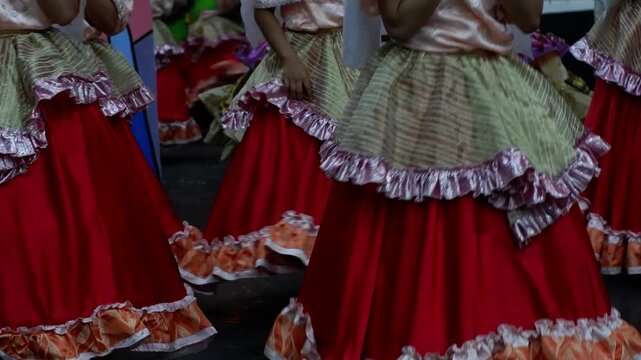 Cultural dancers twirl in their skirts as they perform at a trade fair presentation.