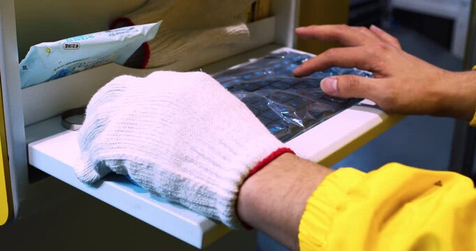 Controlling modern industrial equipment using a keyboard. Close-up of the operator's hands operating the machine.
