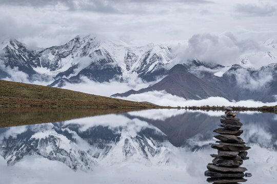 Lenggacuo Lake reflects Daxue Mountain Range with Mount Gongga in the background in Sichuan, China