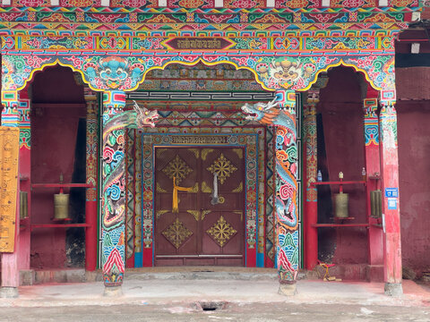 Intricate doorway of Tibetan monastery showcasing vibrant designs and symbols of Himalayan Buddhist culture in Yunnan