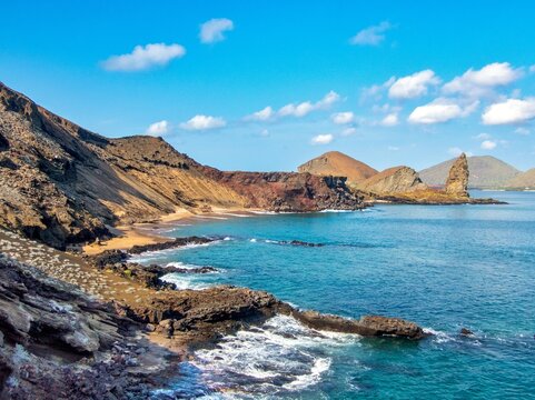 Explore Pinnacle Rock in Galapagos Islands on Bartolome Island with beautiful coast and volcanic landscape in Ecuador