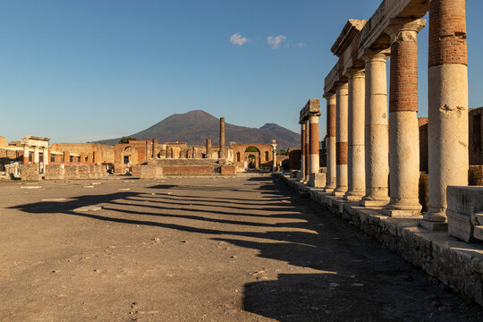 Exploring ancient Pompei ruins with Mount Vesuvius in the background in Campania, Italy