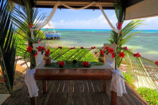 Tropical wedding setup at Coco de Mer resort in Seychelles with ocean views and floral decorations for a special event