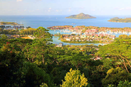 View of Eden Island from a high point in Seychelles with green trees and blue water in the background