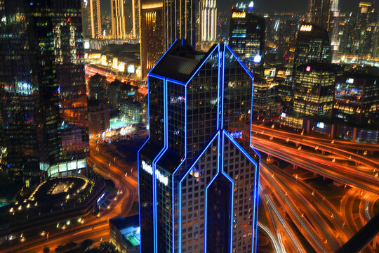 Evening view of central Dubai with Burj Khalifa illuminated, showcasing the vibrant city life and traffic flow