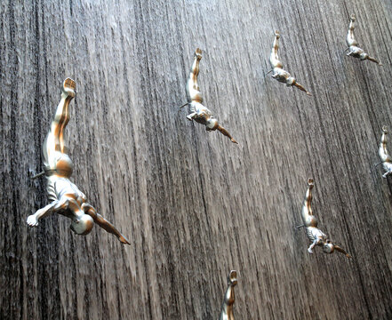 Waterfall sculptures display divers in Dubai Mall showcasing art and design in a unique setting
