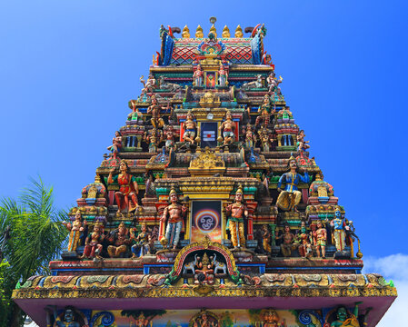 Draupadee Ammen Kovil Hindu Temple in Goodlands shows colorful sculptures and detailed architecture under clear sky in Mauritius