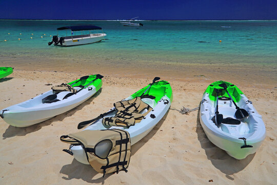 Kayaks lined up on the beach at Flic en Flac in Mauritius ready for a day of water activities