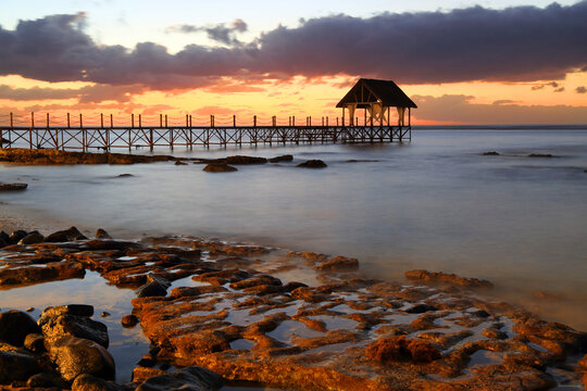 Sunset view from pier in Pointe Aux Piments, Mauritius as daylight fades into evening