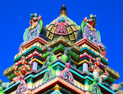 Exploring the intricate details of a Hindu temple in Mahebourg, Mauritius during bright daylight